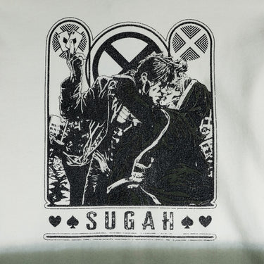 A dip-dyed hoodie in cream and green featuring X-Men's Rogue and Gambit. The front displays a small X-Men logo, while the back showcases a black-and-white comic-style illustration of Rogue and Gambit embracing, with the word "Sugah" below.