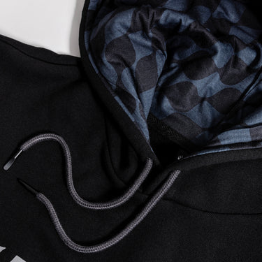 Close-up of the Aetherdrift Black Hoodie showing black fabric, gray drawstrings, and checkered hood lining.