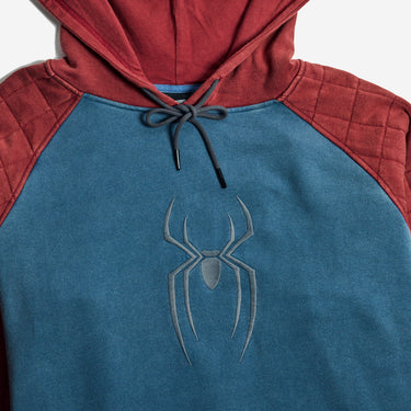 A close-up of a Spider-Man themed pullover hoodie with a teal blue body, red hood and shoulder yoke, black drawstrings, and a gray spider logo on the chest.