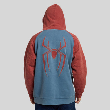 A person shown from the back wearing a Spider-Man themed hoodie with a blue back panel, red sleeves, and a large red spider emblem on the back, against a plain light gray background.
