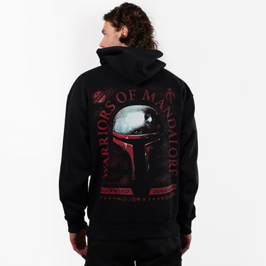 Person wearing a black hoodie with 'Warriors of Mandalore' design on the back, on a white background