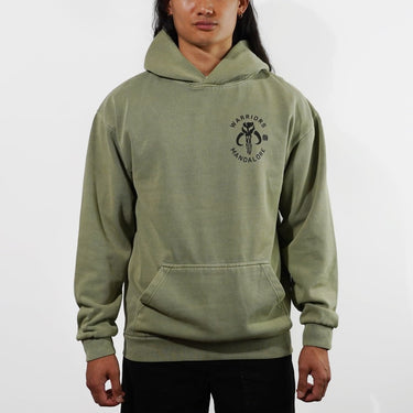 Person wearing a Green hoodie with a Warriors of Mandalore logo on the chest against a white background