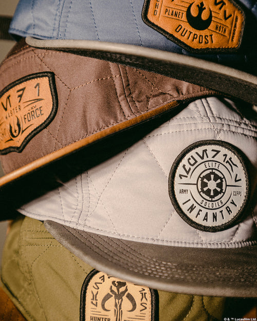 a stack of hats with logos