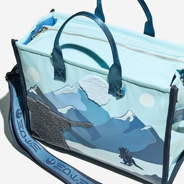 Light blue bag with mountain design on a white background