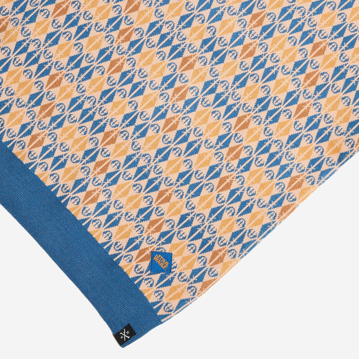 Patterned fabric with blue and orange design on a white background