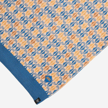 Patterned fabric with blue and orange design on a white background