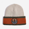 Photo shows a beige knit beanie. This beanie has a folded cuff that has a wide orange stripe between two smaller dark green stripes on the top and bottom. There is a patch embroided on the center of the cuff. The patch features the REBEL emblem from Star Wars with a wooded motif within the Rebel emblem. 