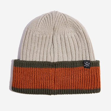 Photo shows a beige knit beanie. This beanie has a folded cuff that has a wide orange stripe between two smaller dark green stripes on the top and bottom. There is a small woven tag on the top of the cuff to the right that has the letters "H" and "V" to represent the brand Heroes and Villains