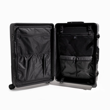 Black open suitcase showing organizational pockets on a white background