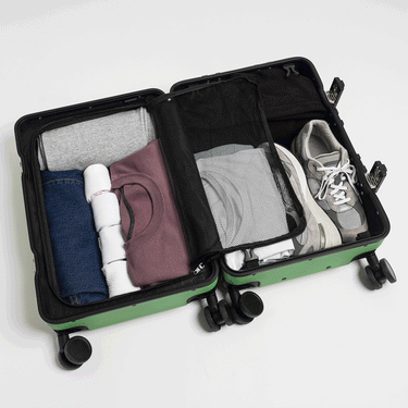 Gif showing a packed suitcase. Thegif flips between a photo of the zipper compartment closed and toiletry hanger attached to a photo of the toiletry hanger removed and the zippered compartment open