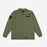 The photo shows a military style shirt jacket. The jacket is a thick canvas material and features 2 patches on the right chest and a patch on the left sleeve. The jacket has buttons as a closer and 2 chest pockets. 