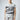Sleeveless light gray sweatshirt featuring a large vintage-style graphic of "Gotham City" with a bat silhouette and the text "Est. 1939" in distressed black print. A small Batman logo is also present at the bottom right of the design
