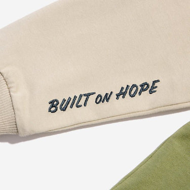 A close up of the sleeve detailing that says "Built on hope"