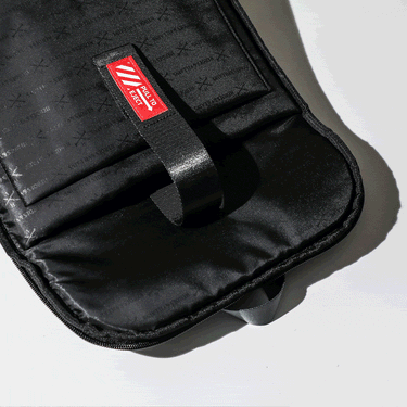 Gif showing laptop being pulled out of a backpack using a strap that says "eject"