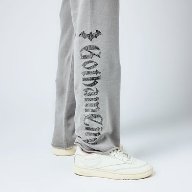 Close up detail of sweatpants. The leg has "Gotham City" in black text down the leg