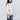 Woman in a White Button Up Cardigan featuring embroidered cherry blossoms