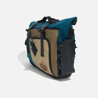 Side view of the water bottle pocket on the Heroes & Villains Rebel Teal Commuter Bag.