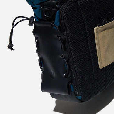 Close-up of the water bottle pocket on the side of the Heroes & Villains Rebel Teal Commuter Bag.