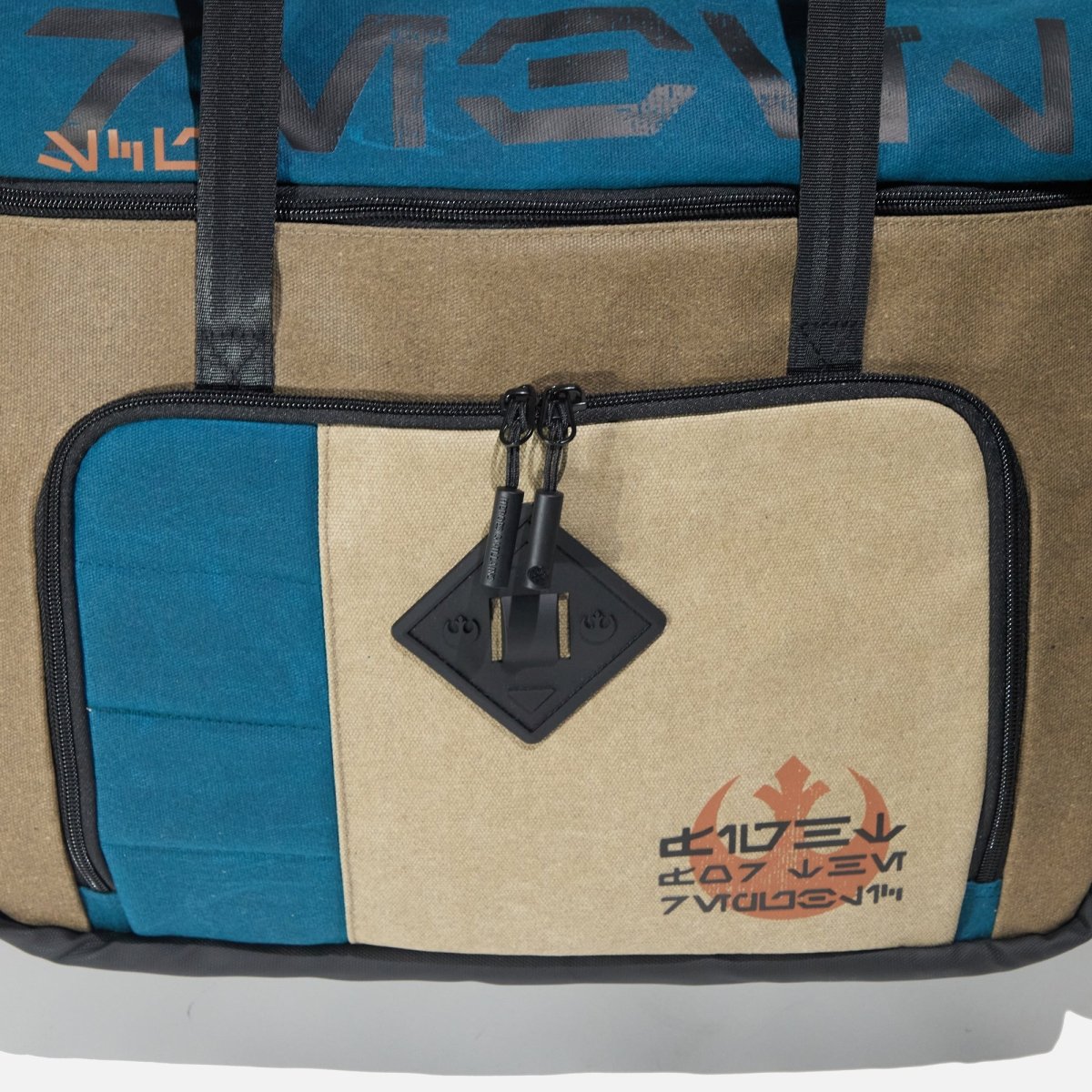 Front view of the Heroes & Villains Rebel Teal Commuter Bag and the Aurebesh.