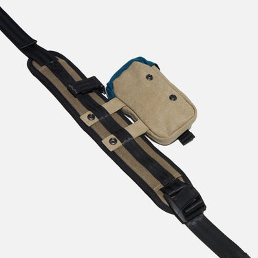 Close up of the snap closures on the shoulder strap of the Heroes & Villains Rebel Teal Commuter Bag.