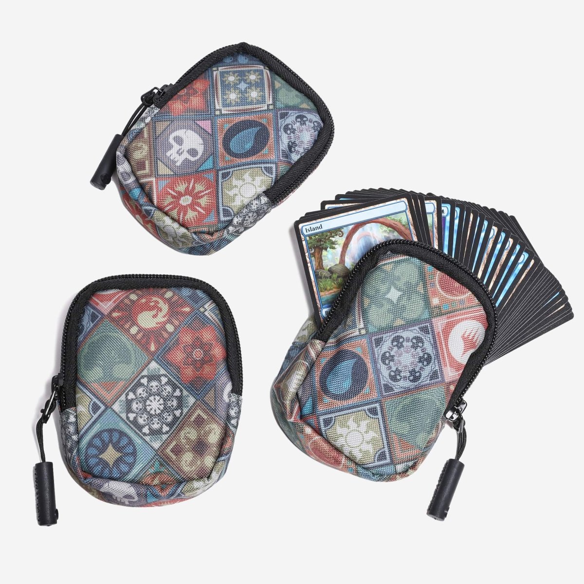 Three patterned card cases with a deck of cards on a white background