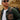 Man wearing sunglasses and a green jacket with a Star Wars The Mandalorian Backpack with Tech Organizer attached