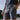 Person wearing patterned star wars athletic shorts with a mudhorn logo, standing outdoors.