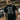 Man wearing a Black T-Shirt with Graphic of Cyclops from the X-Men '97 TV Show in an concrete setting