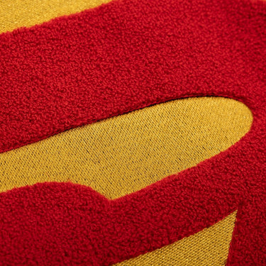 Close-up of red and yellow textured fabric from an "S-Symbol" Superman Patch