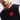Man wearing a Navy varsity jacket with a Superman logo on a white background