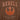 A close up of the back of a Star Wars-themed hooded windbreaker jacket, primarily brown with orange accents. The design features large, bold text reading 'REBELS' across the upper back, with the Rebel Alliance emblem in orange below it. Beneath the emblem, the words 'ALLIANCE FORCES' are printed in a smaller font. The jacket has an elastic waistband and cuffs, with a color-blocked pattern matching the front design.