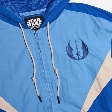A close up of a Star Wars-themed hooded windbreaker jacket featuring a Jedi Knights emblem on the left chest. The jacket has a color-blocked design in Blue, Light Blue and White, with a front zipper, adjustable drawstrings on the hood