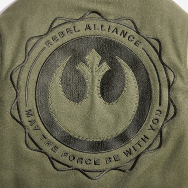 The photo shows a close up of a large circular embroidery featuring the Star Wars Rebel emblem. There is text  that says "Rebel Alliance" at the top and "May the force be with you" at the bottom in a circular shape around the rebel emblem.