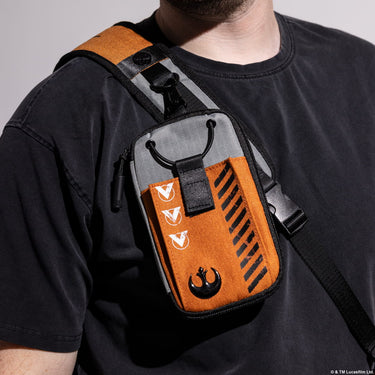 Person wearing a Star Wars themed crossbody bag with orange and gray design.