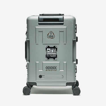 Gray suitcase with branding and design elements on a white background