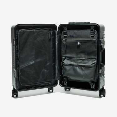 Black suitcase with open compartments on a white background