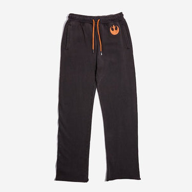 Dark Grey sweatpants with an elastic waistband and orange drawstring, featuring a small orange rebel logo near the left pocket and a vertical "Rebel" graphic printed in distressed black text along the lower left leg.