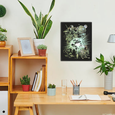 Home office with wooden desk, plants, and framed artwork on a white wall.
