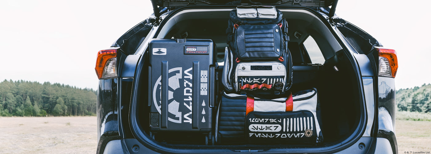 a group of luggage in the trunk of a car