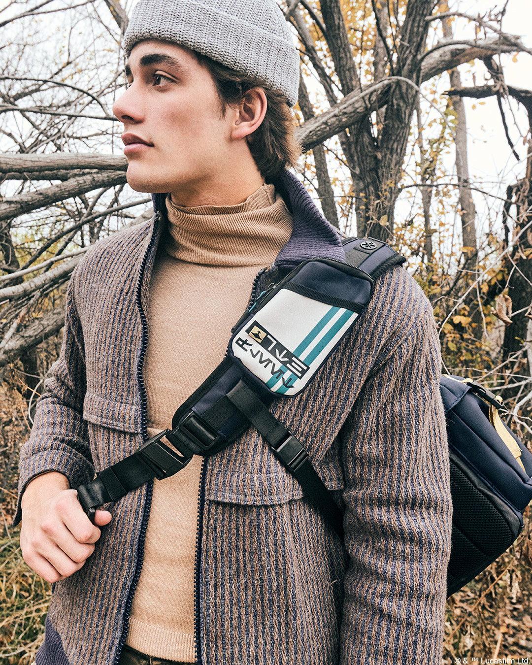 Male utilizing Shoulder strap to the Heroes & Villains Thrawn Bike Messenger Bag in a nature scene.