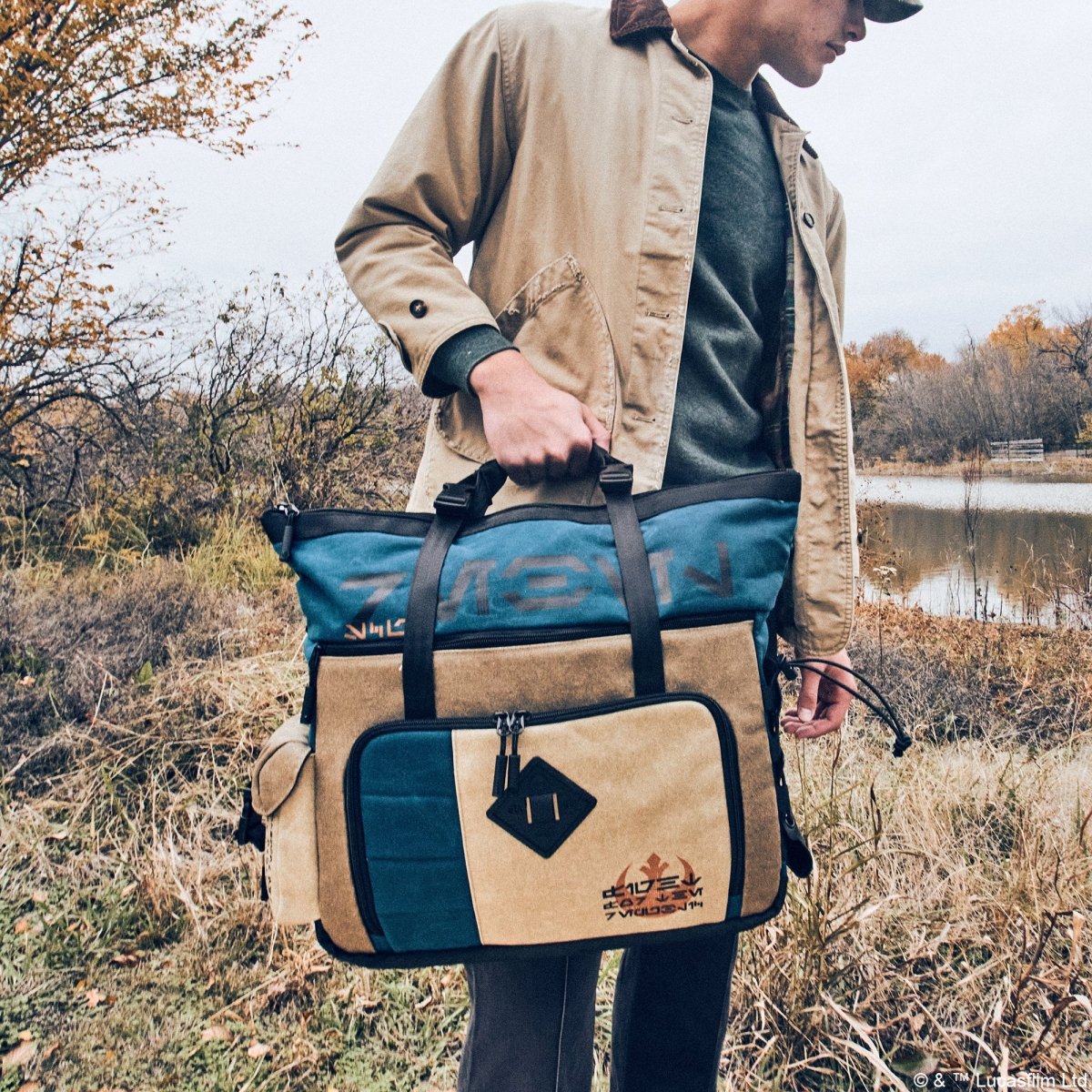 Male carrying the Heroes & Villains Rebel Teal Commuter Bag in nature.