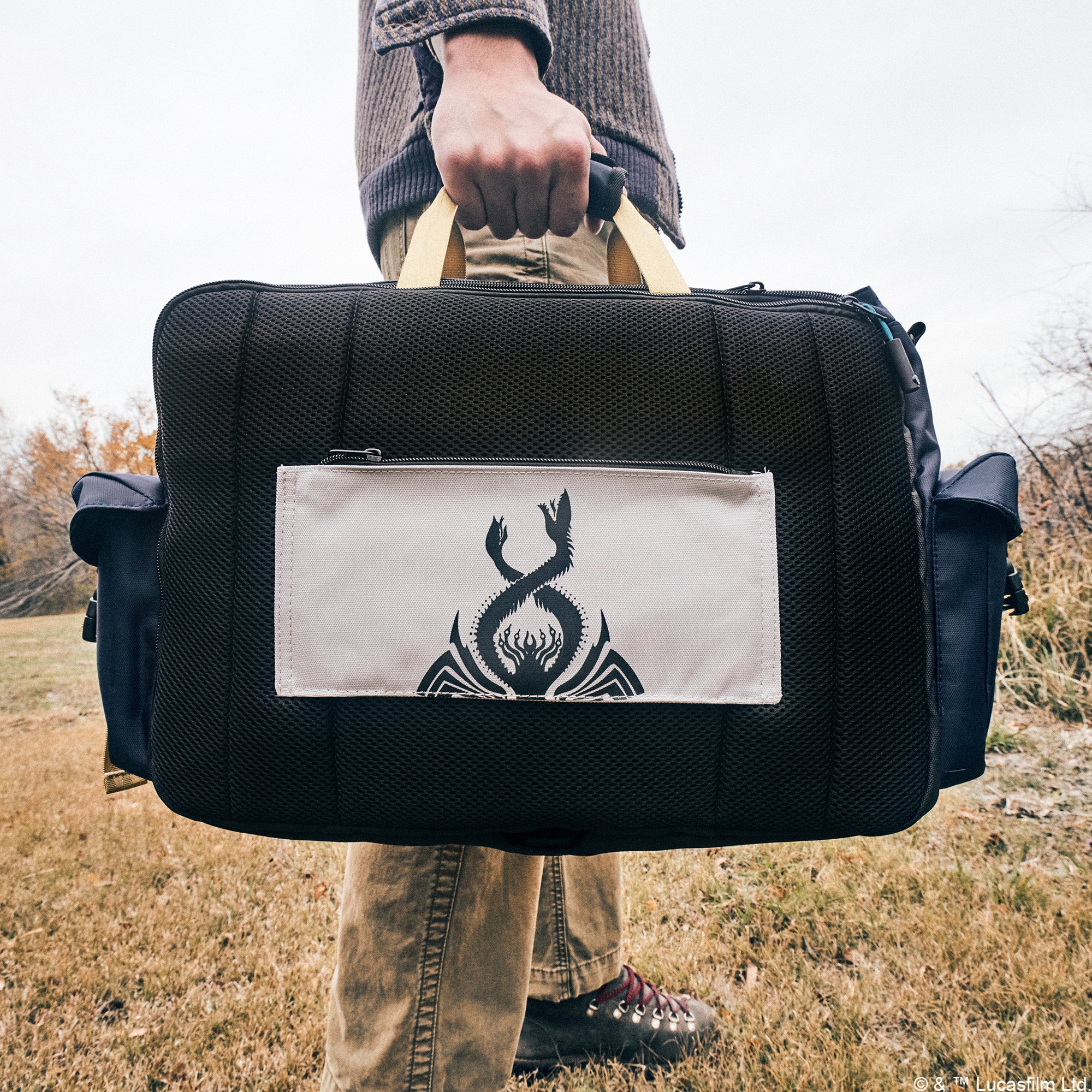 Back view of Heroes & Villains Thrawn Bike Messenger Bag showcasing trolley sleeve in a nature scene.