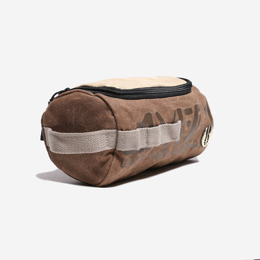 Brown toiletry bag with a black zipper on a white background