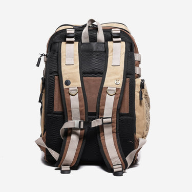 Backpack with multiple straps and compartments on a white background