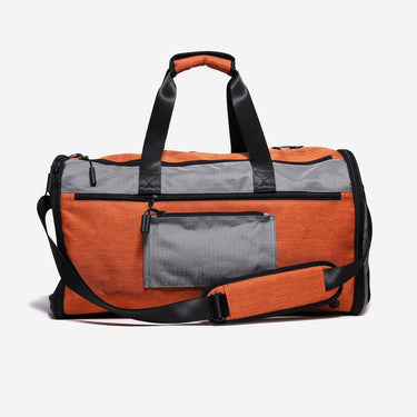 Orange and gray duffel bag with black straps on a white background
