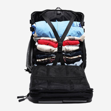 Travel Backpack open showing Compression Strap holding Clothing