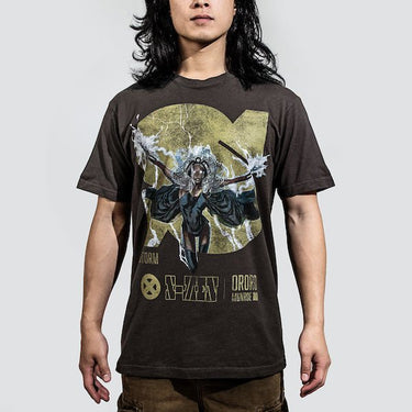 Man in a brown tee featuring a faded graphic of Storm from X-Men