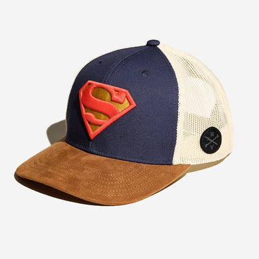 A photo of a trucker hat. It has a white mesh back, a brown suede bill and the front is blue dawning the S-Shield from Supermans uniform