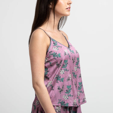Side view of female modeling the front view of the Lore Olympus Goddess of Spring Satin Cami in pink with an all-over floral print.
