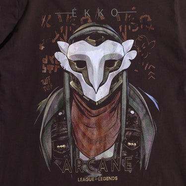 A brown Arcane x League of Legends t-shirt featuring Ekko wearing his signature mask and red scarf. The design includes stylized graffiti-like text, with ‘Ekko’ at the top and ‘Arcane’ and ‘League of Legends’ at the bottom in a bold font